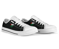 White low-top sneakers, white laces, black side panel with green/red graphic
