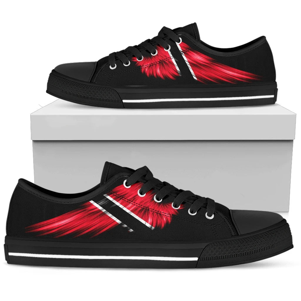 Black low-top sneakers on box; red wing print on side, lace-up, black sole.