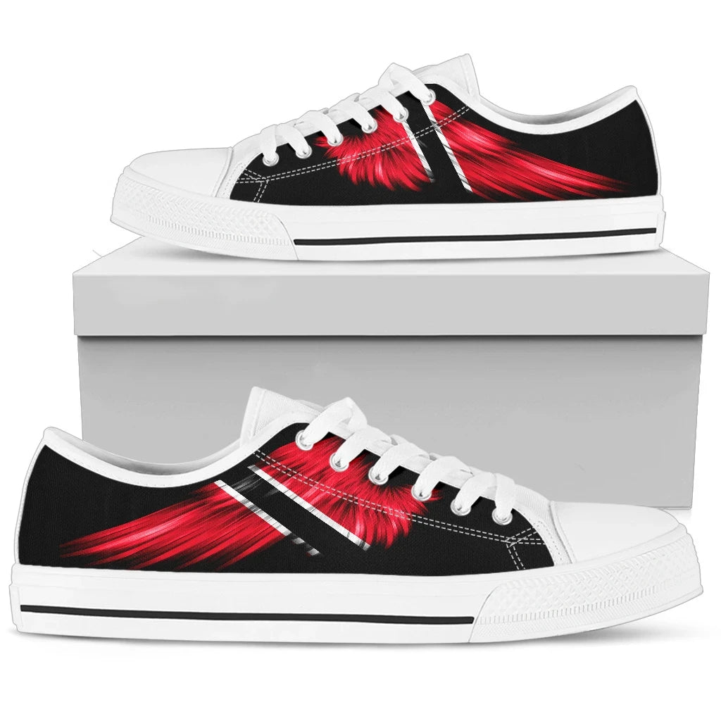 White low-top canvas shoes on box; red wing graphic and striped side panel.