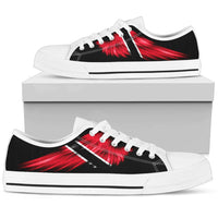 White low-top canvas sneakers with red wing graphic, striped side, lace-up.