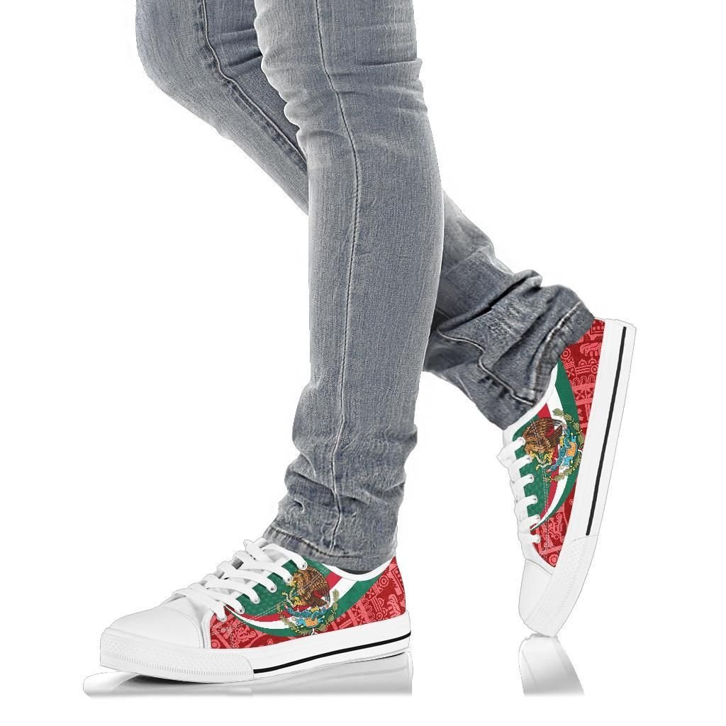 Mexico coat of arms low-top sneakers, white sole, worn with light blue jeans