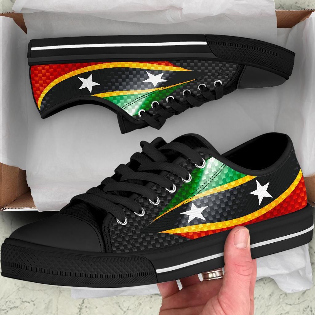 Low-top sneakers, black uppers with colorful flag graphic and white star detail