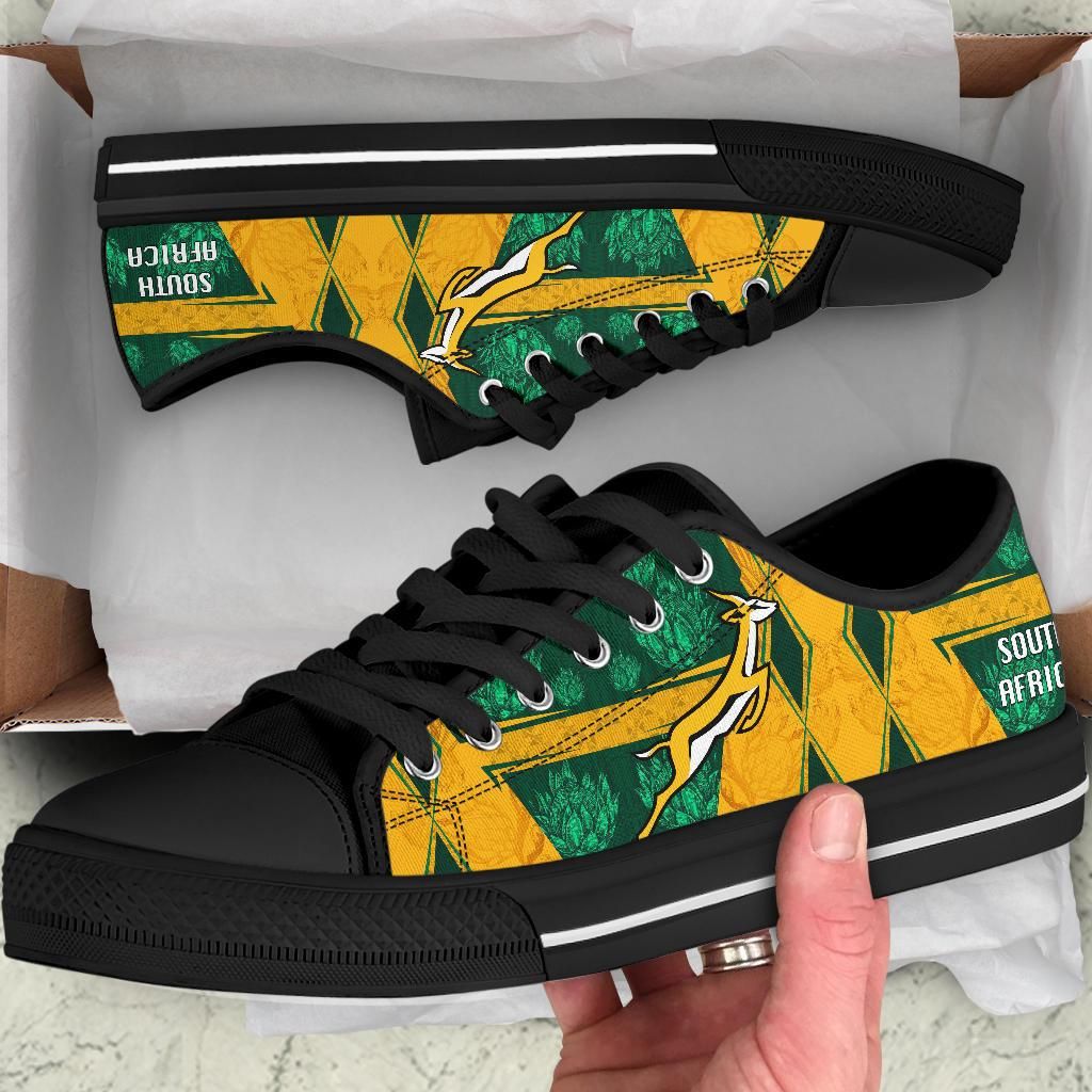 South Africa low-top shoes, black sole; close-up green/yellow design with 'SOUTH AFRICA'