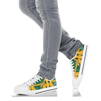 South Africa low-top shoes on jeans, white sole; green/yellow panel and white laces