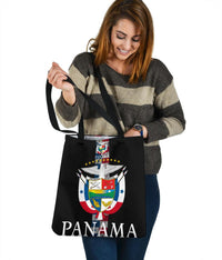 Black tote bag with Panama crest artwork and “PANAMA” wordmark, carrying by handles