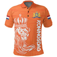 Orange polo with lion emblem and face graphic, Koningsdag text, blue-white sleeve stripes