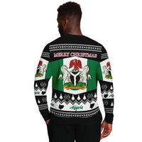 Model wearing unisex Nigeria Christmas sweatshirt, black back view with “Merry Christmas” design