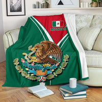 Mexican pride blanket with green panel and red crest, white border stripes and eagle emblem