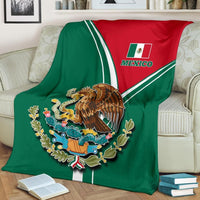 Mexico-themed blanket draped on couch: green-and-red shield with eagle and “MEXICO” text
