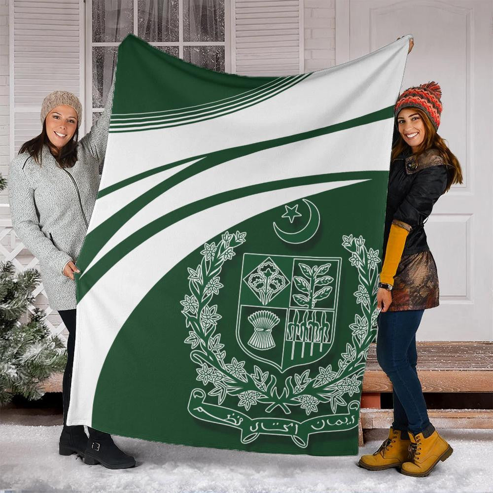 Pakistan coat of arms blanket held up outdoors, green stripe and crest design