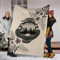 Beige Costa Rica blanket with large emblem and hibiscus palm leaf pattern
