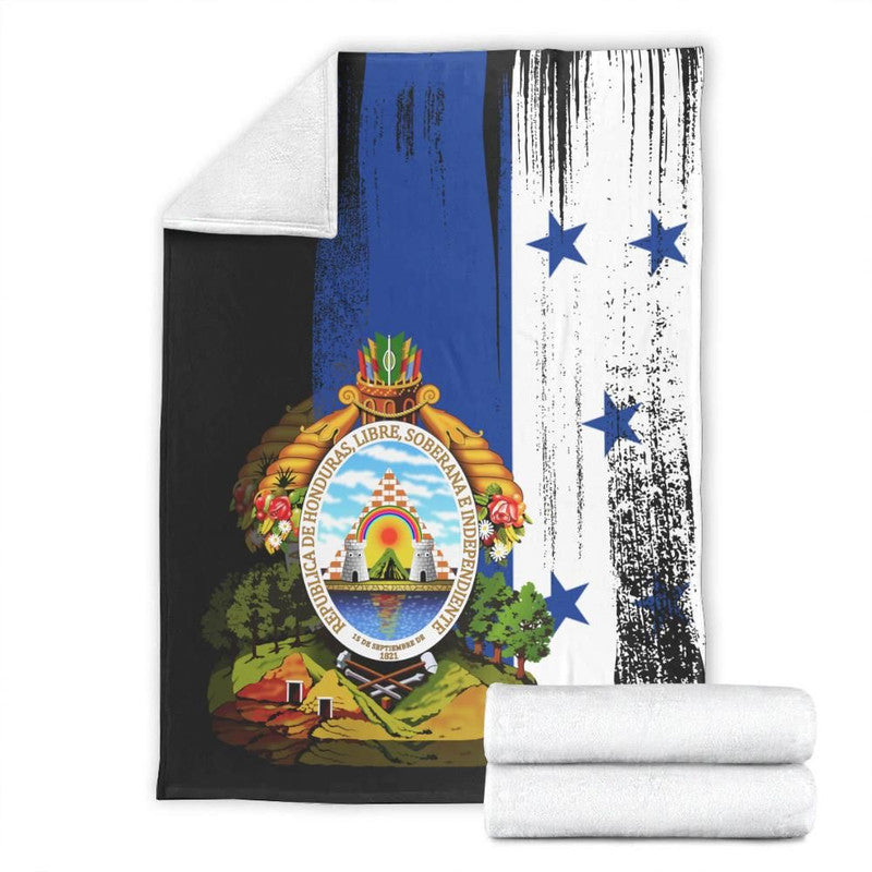 Folded Honduras flag blanket with crest and blue stars on white, black, and blue panels