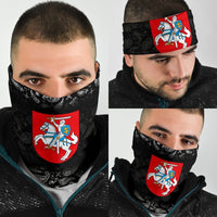 Black neck gaiter with white paisley pattern and Lithuania knight crest; worn covering nose.