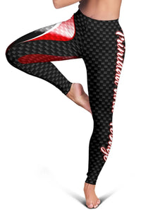 Close-up of women’s leggings: black checkered fabric with red top stripe and white border