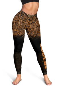 Front view black leggings with gold-brown Aztec calendar print on thighs and shins.