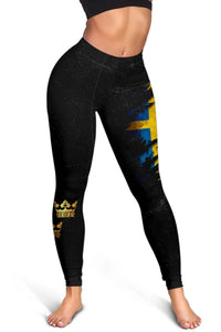 Legs-only view of black leggings with blue-and-yellow Swedish flag and crown band