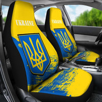 In-car view of Ukraine seat covers: yellow backrests, blue lower panel with trident emblem