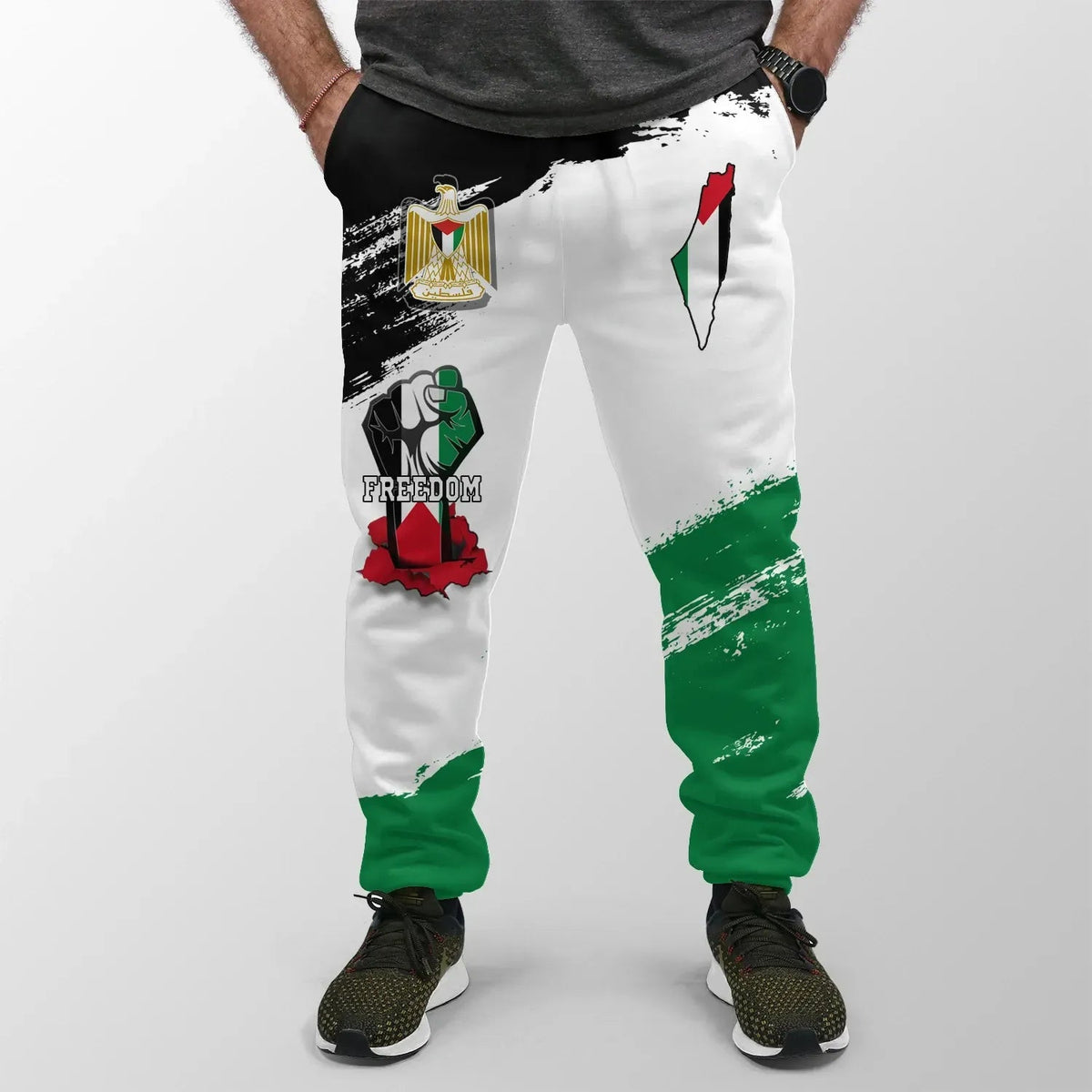 White jogger pants with green and red accents, Freedom text graphic on left leg
