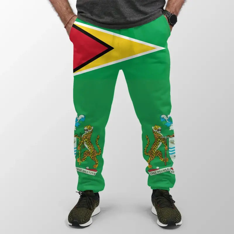 Green jogger pants with Guyana flag chevron and leopard crest at cuffs, drawstring hem