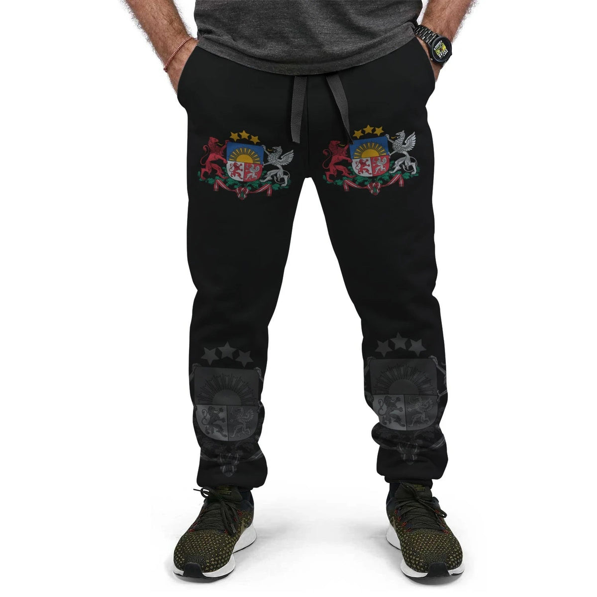 Black joggers with multicolor crest on hips and star-and-emblem prints at lower legs