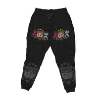 Black joggers flat lay with multicolor crest on knees and star emblem panels on cuffs