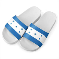 Pair of Honduras flag slide sandals with blue star straps, white footbeds and black outer soles