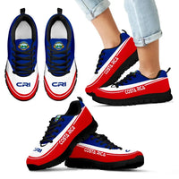 Costa Rica sneakers with jeans, black outsole, blue upper, red side stripe, black laces