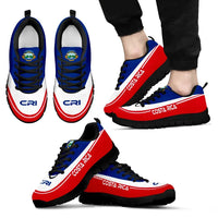 Costa Rica sneakers on feet, dark outsole, blue upper, red side stripe, black laces