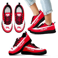 Red Poland sneakers with black sole and crest emblem; chunky outsole view.