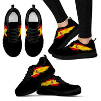 Black sneakers with colorful flame/crest print and black sole, lace-up design