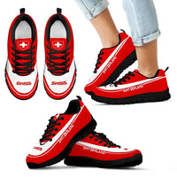 Red sneakers with black sole and Swiss cross emblem, "SWITZERLAND" side lettering, worn