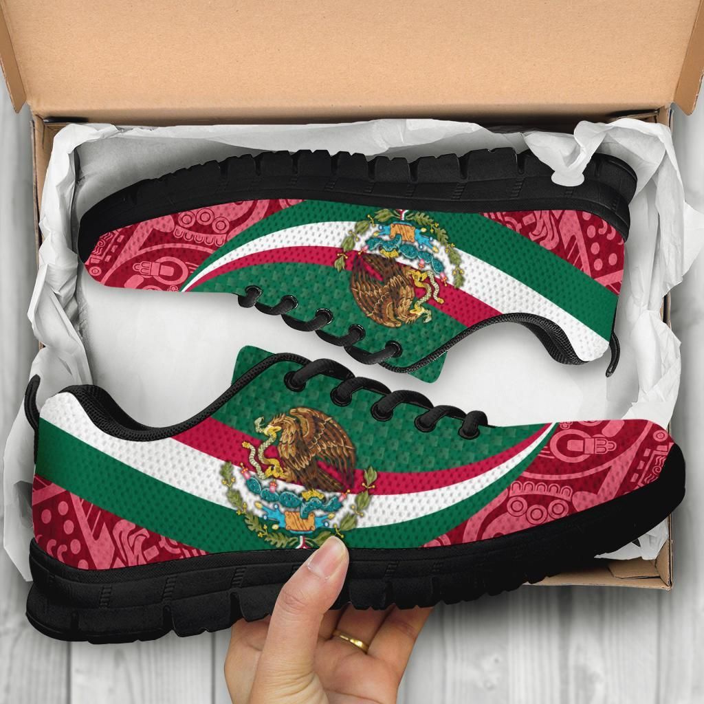 Black sole sneakers in box; green-red-white stripes with coat of arms and Aztec-style print