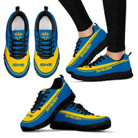 Sweden sneakers blue and yellow with black laces, black soles, worn with pants