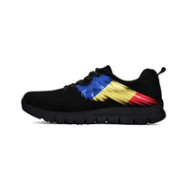 Black sneakers with colorful stripe graphic, black laces, and dark tread sole
