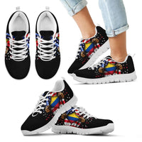 Black sneakers worn with open hand Colombia flag print, white sole and white laces