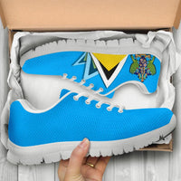 Blue sneakers in box, white laces and crest/flag graphic, white outsole