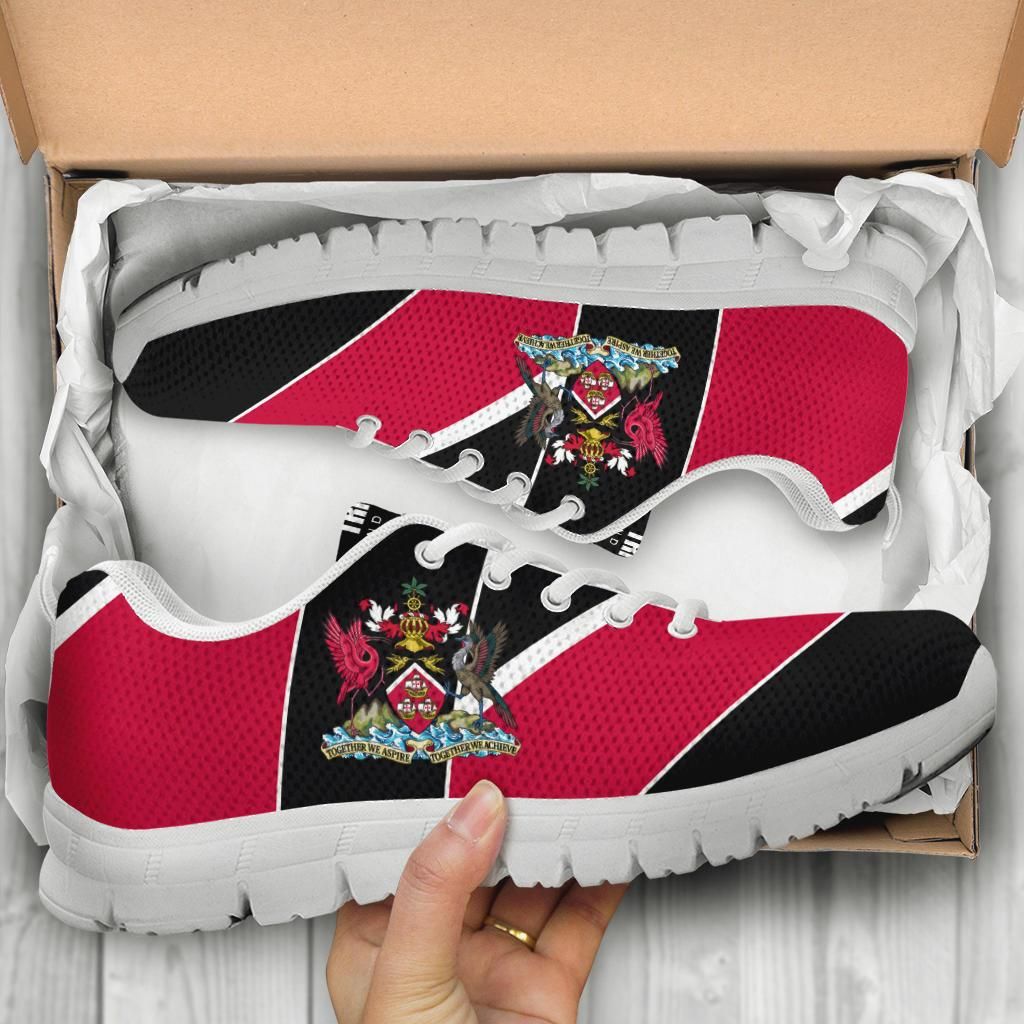 Red and black Trinidad sneakers close-up, crest badge, white laces, chunky white sole