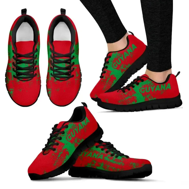 Guyana smudge-style sneakers, red upper with green “GUYANA” print, black laces, black sole