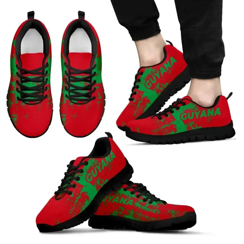 Guyana smudge sneakers on feet, red with green “GUYANA” graphic, black laces, black sole