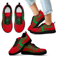 Guyana smudge-style sneakers pair, red and green “GUYANA” graphic, black laces, black sole