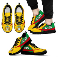 Active sneakers with yellow, green & red print, black sole, lace-up, on feet