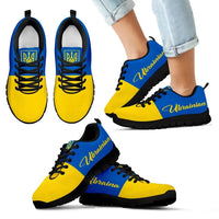 Ukrainian flag sneakers on feet, yellow and blue uppers with black laces, black sole