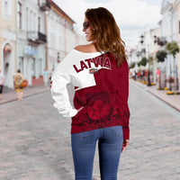 Back view: maroon and white off-shoulder sweater with LATVIA print and crest emblem