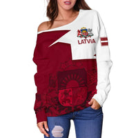 Maroon and white off-shoulder sweater with Latvia text, crest, and flag stripe detail