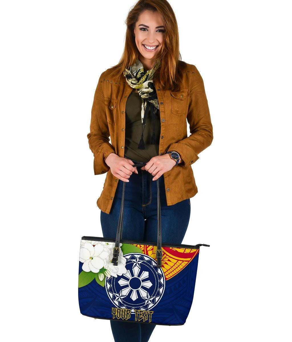 Blue patterned tote with wheel graphic and floral patch, black straps, top zipper detail