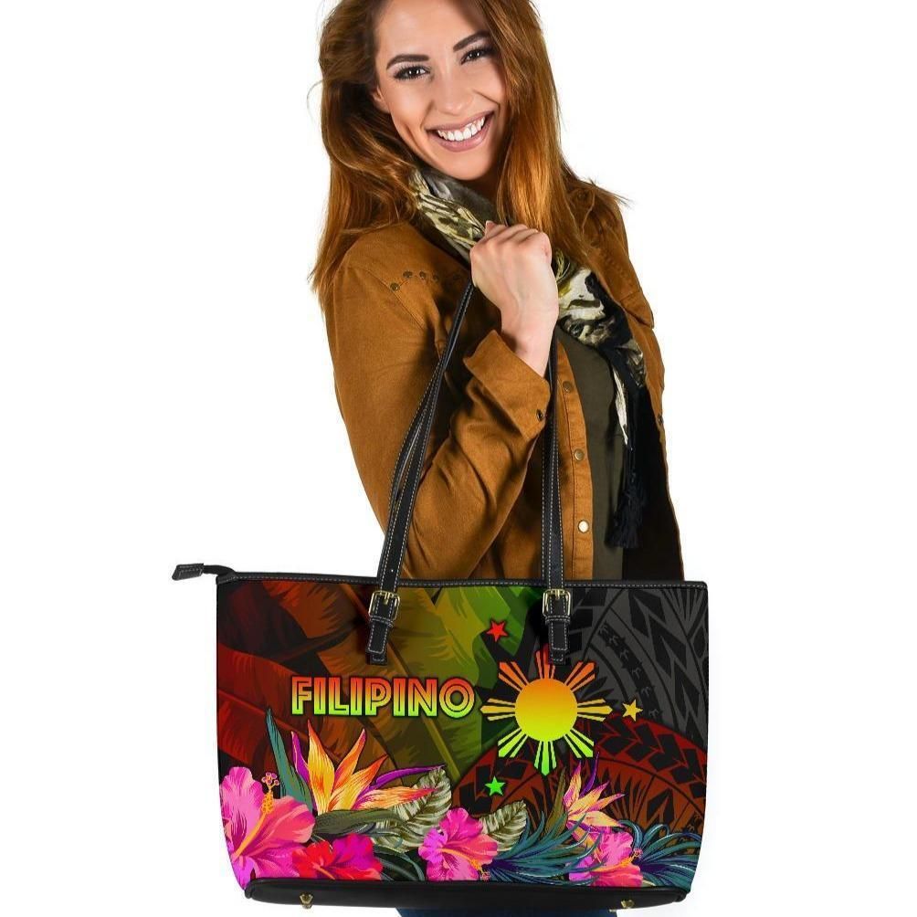 Colorful leather tote bag with black handles, top zipper, floral hibiscus and leaf print