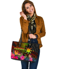 Colorful printed tote bag with black dual handles, FILIPINO text and tropical flowers