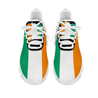 Clunky sneakers front view: white mesh with green and orange side panels, black tongue
