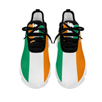 Clunky sneakers front view: black toe, white mesh, green and orange side panels