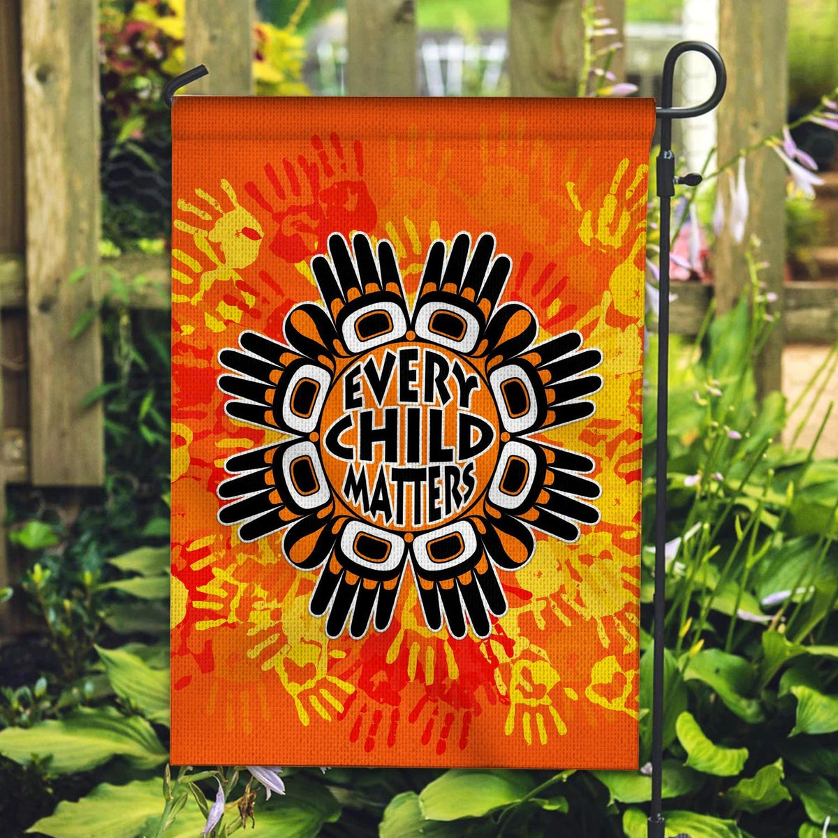 Orange yard flag with bold “Every Child Matters” text and handprint sunburst design